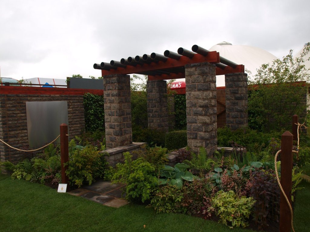 Award-winning show garden at BBC Gardeners’ World Live with stone pergola and layered planting